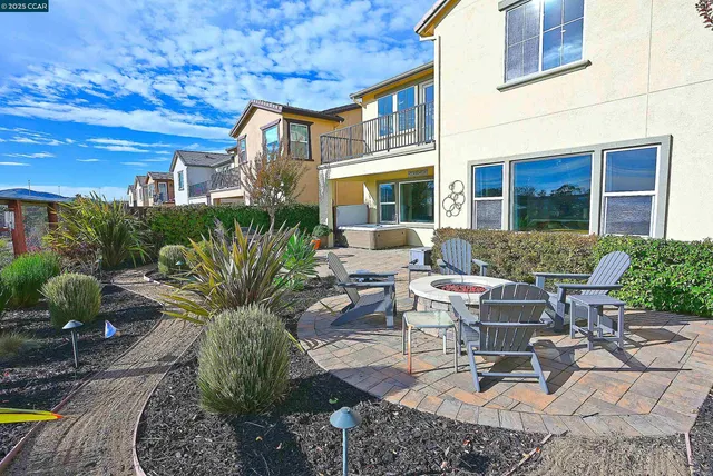 a view of a patio with couches table and chairs and potted plants