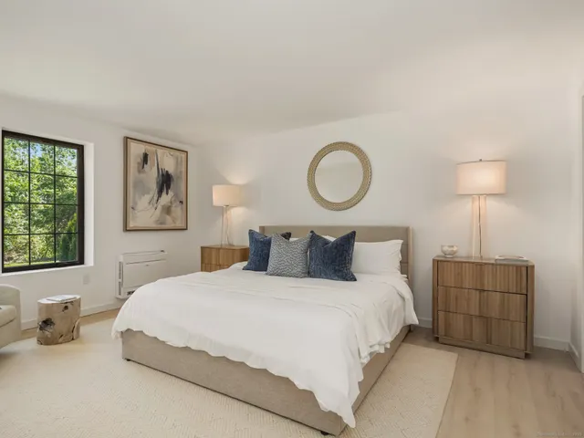 a bedroom with bed and a night stand