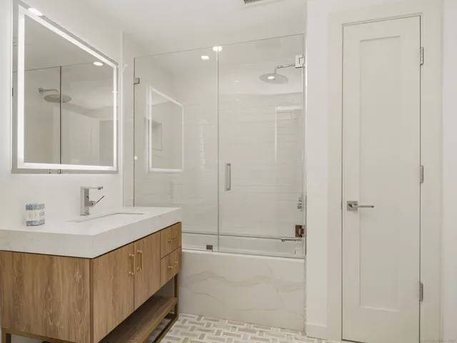 a bathroom with a double vanity sink and a mirror