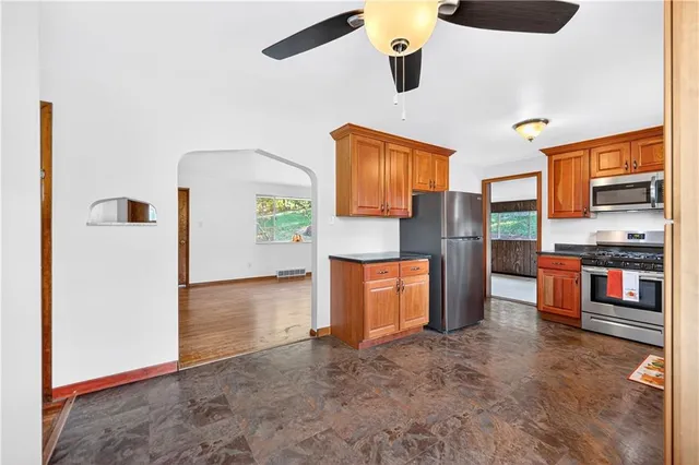 a view of a kitchen with refrigerator and a stove