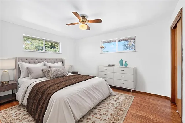 a bedroom with a bed and a painting on the wall