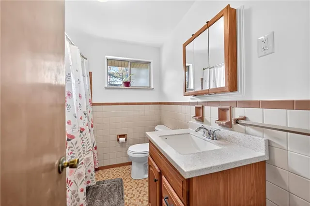a bathroom with a sink toilet and mirror