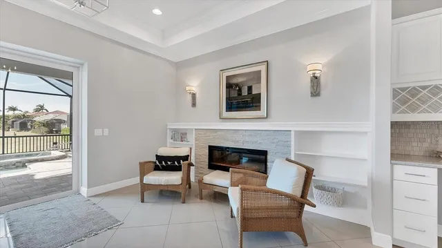 a living room with furniture a fireplace and a book shelf