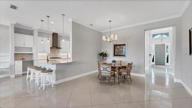a large kitchen with a table and chairs