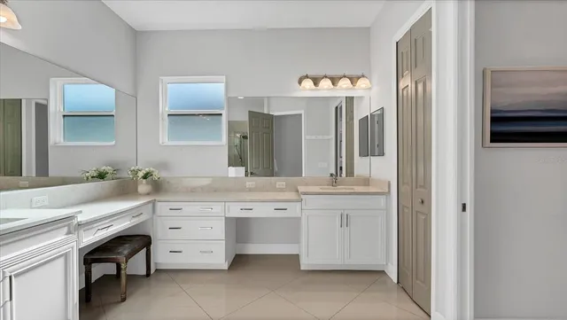 a spacious bathroom with a granite countertop sink and a mirror