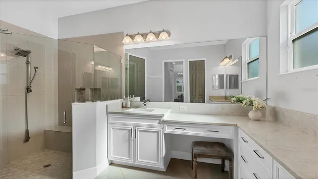 a bedroom with a bed a chandelier and a window