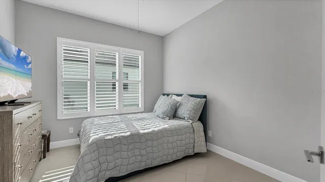 a bedroom with a bed and a television