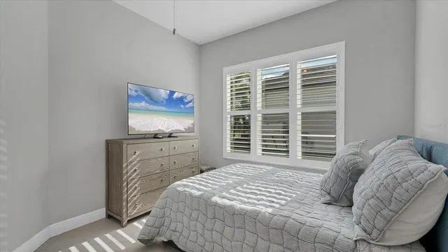 a bathroom with a granite countertop sink a toilet and a mirror
