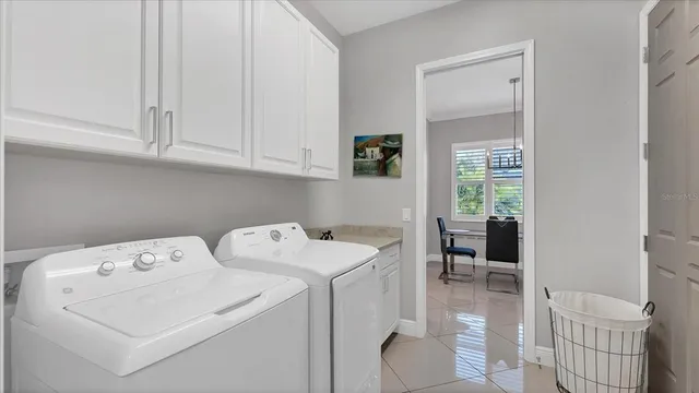a dining room with furniture and a floor to ceiling window