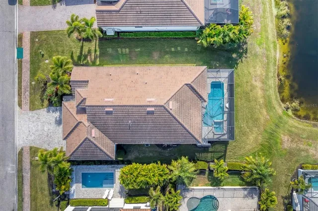 a front view of house with yard and trees in the background