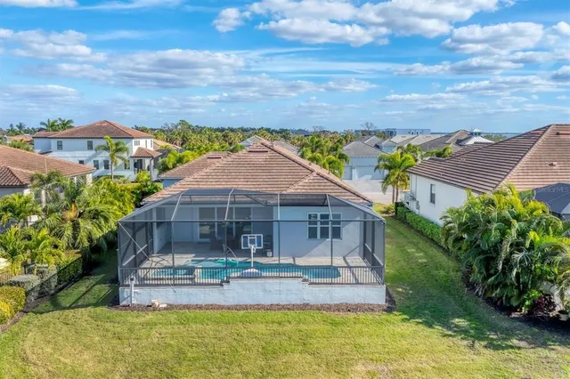 an aerial view of a house with a swimming pool yard and mountain view in back