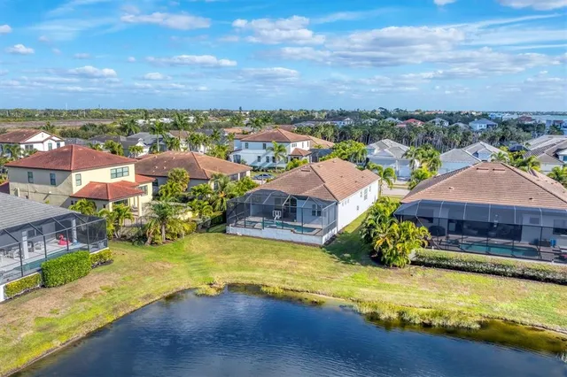 an aerial view of residential houses with outdoor space and ocean view
