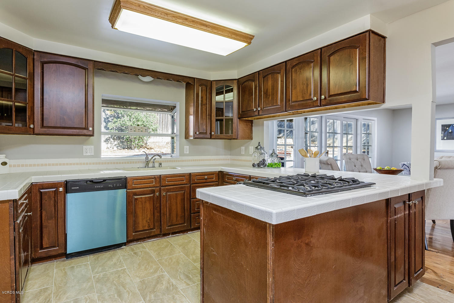 5829 Oak Knolls Road Simi Valley, CA 93063 - Photo 11 of 33 a kitchen with stainless steel appliances granite countertop wooden cabinets a stove top oven a sink and dishwasher