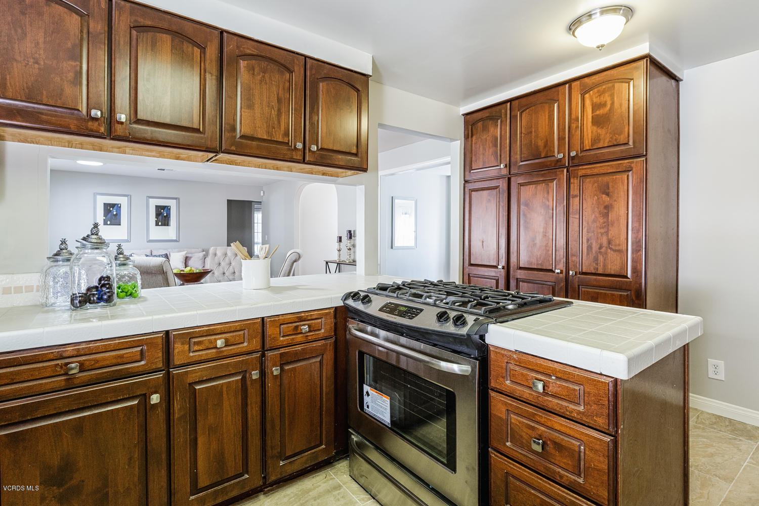 5829 Oak Knolls Road Simi Valley, CA 93063 - Photo 12 of 33 a kitchen with stainless steel appliances granite countertop a stove and a sink
