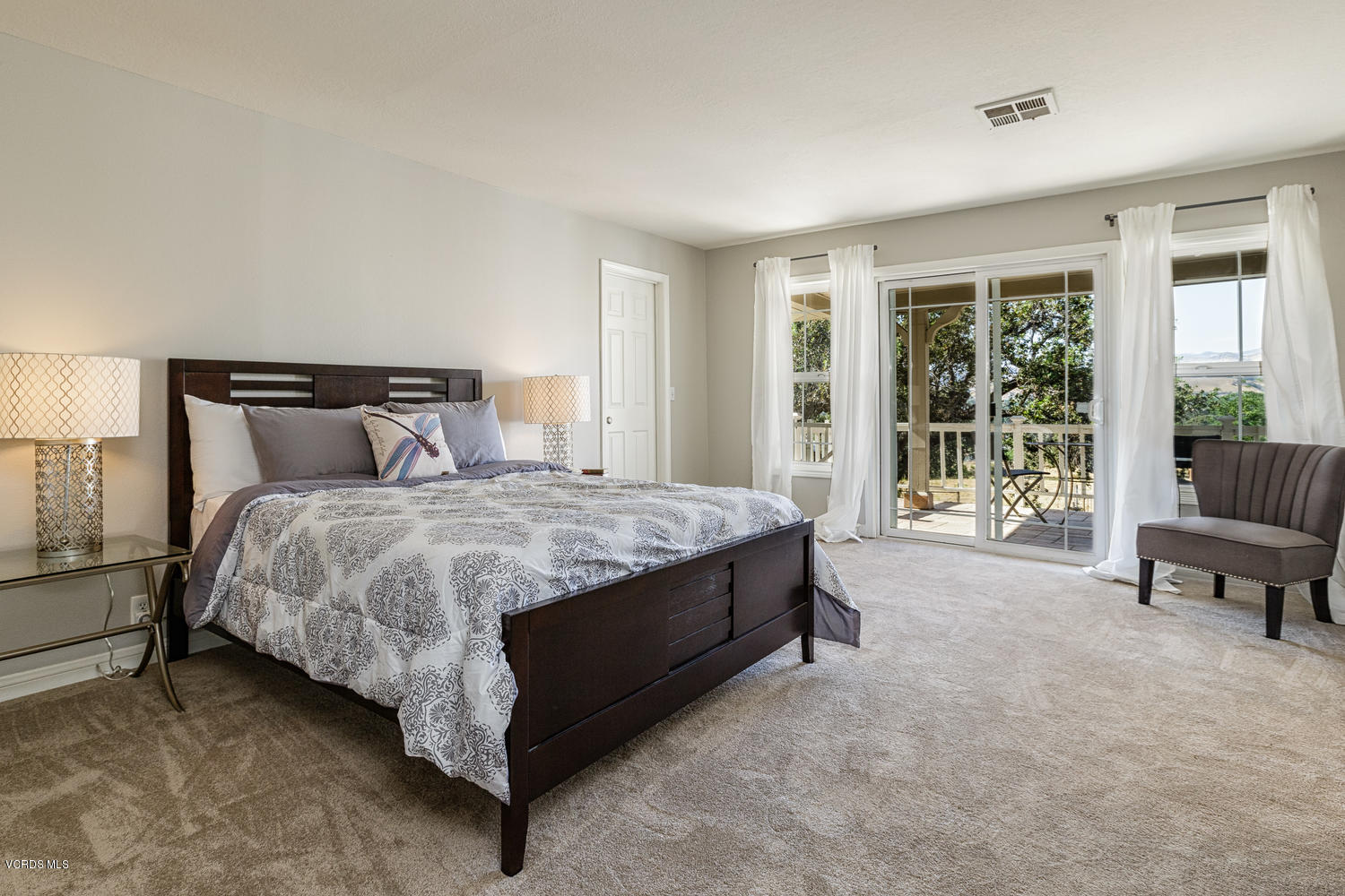 5829 Oak Knolls Road Simi Valley, CA 93063 - Photo 13 of 33 a bed sitting in a spacious bedroom next to a window