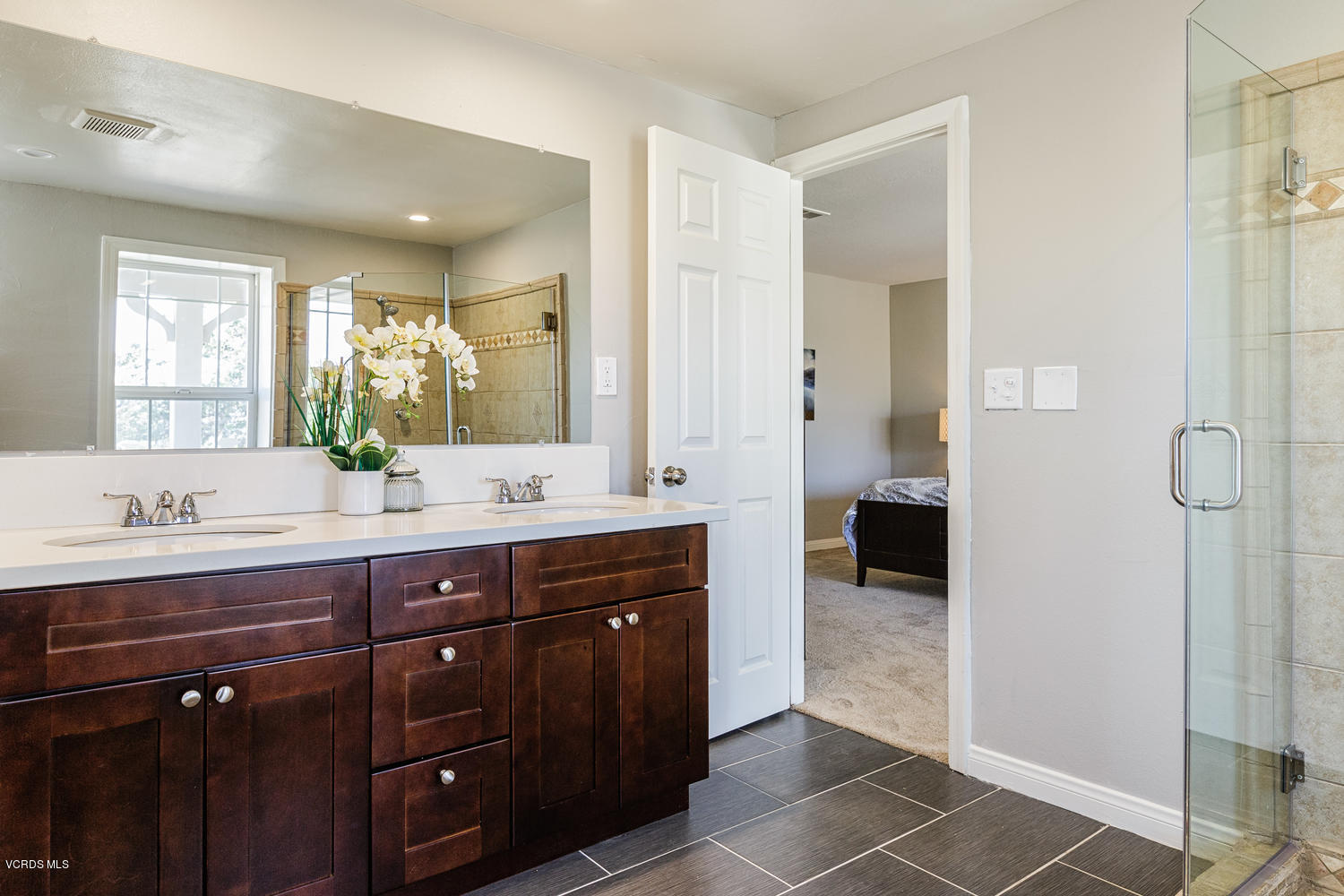 5829 Oak Knolls Road Simi Valley, CA 93063 - Photo 15 of 33 a spacious bathroom with a granite countertop sink a mirror and a shower
