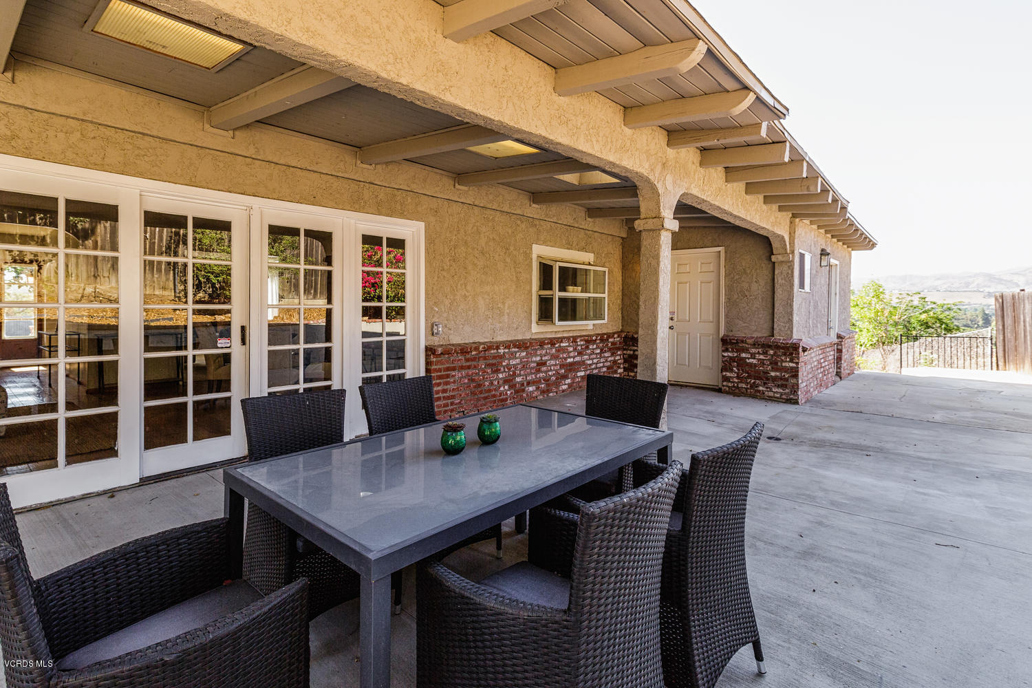 5829 Oak Knolls Road Simi Valley, CA 93063 - Photo 24 of 33 a view of a house with a dining table and chairs