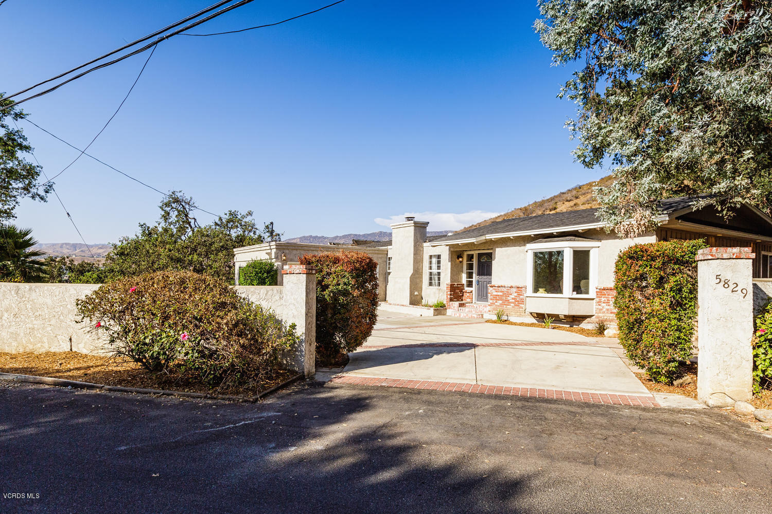 5829 Oak Knolls Road Simi Valley, CA 93063 - Photo 33 of 33 a front view of a house with a yard