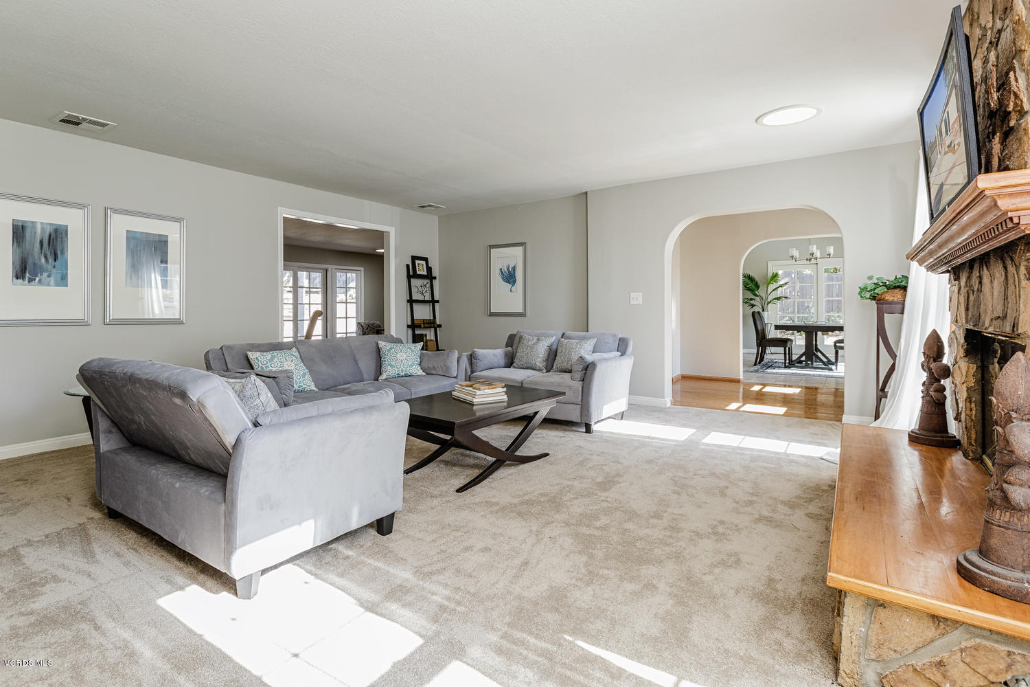 5829 Oak Knolls Road Simi Valley, CA 93063 - Photo 5 of 33 a living room with furniture and a large mirror next to a window
