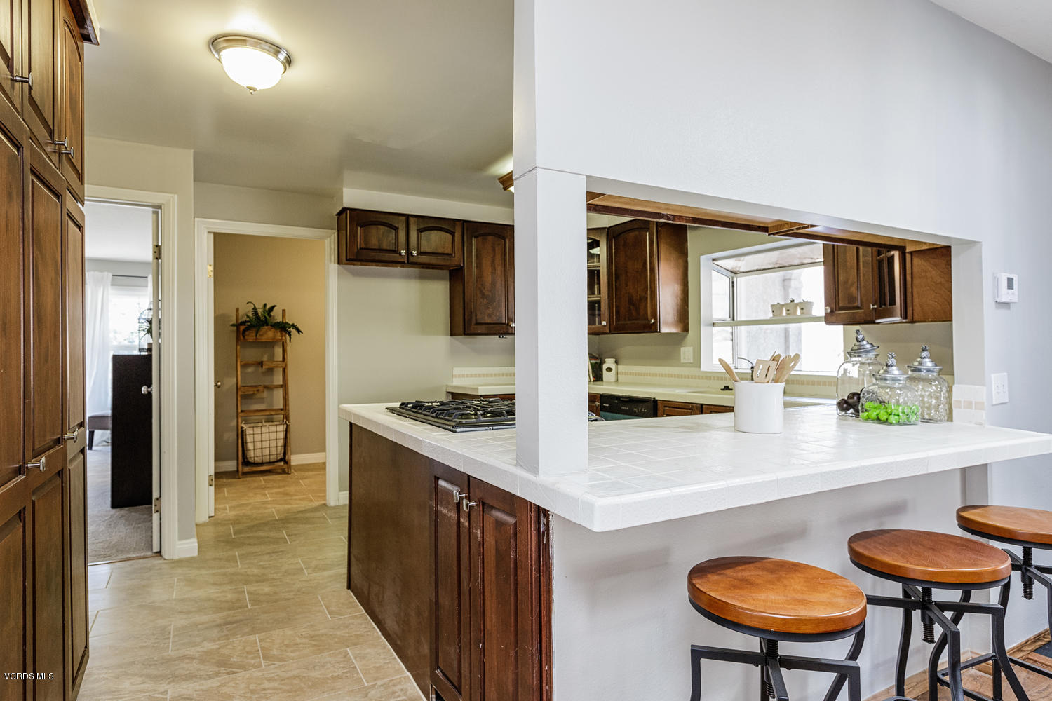 5829 Oak Knolls Road Simi Valley, CA 93063 - Photo 10 of 33 a kitchen with stainless steel appliances granite countertop a refrigerator a stove and a sink with wooden floor