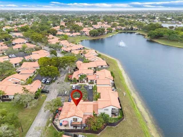 an aerial view of residential houses with outdoor space and swimming pool