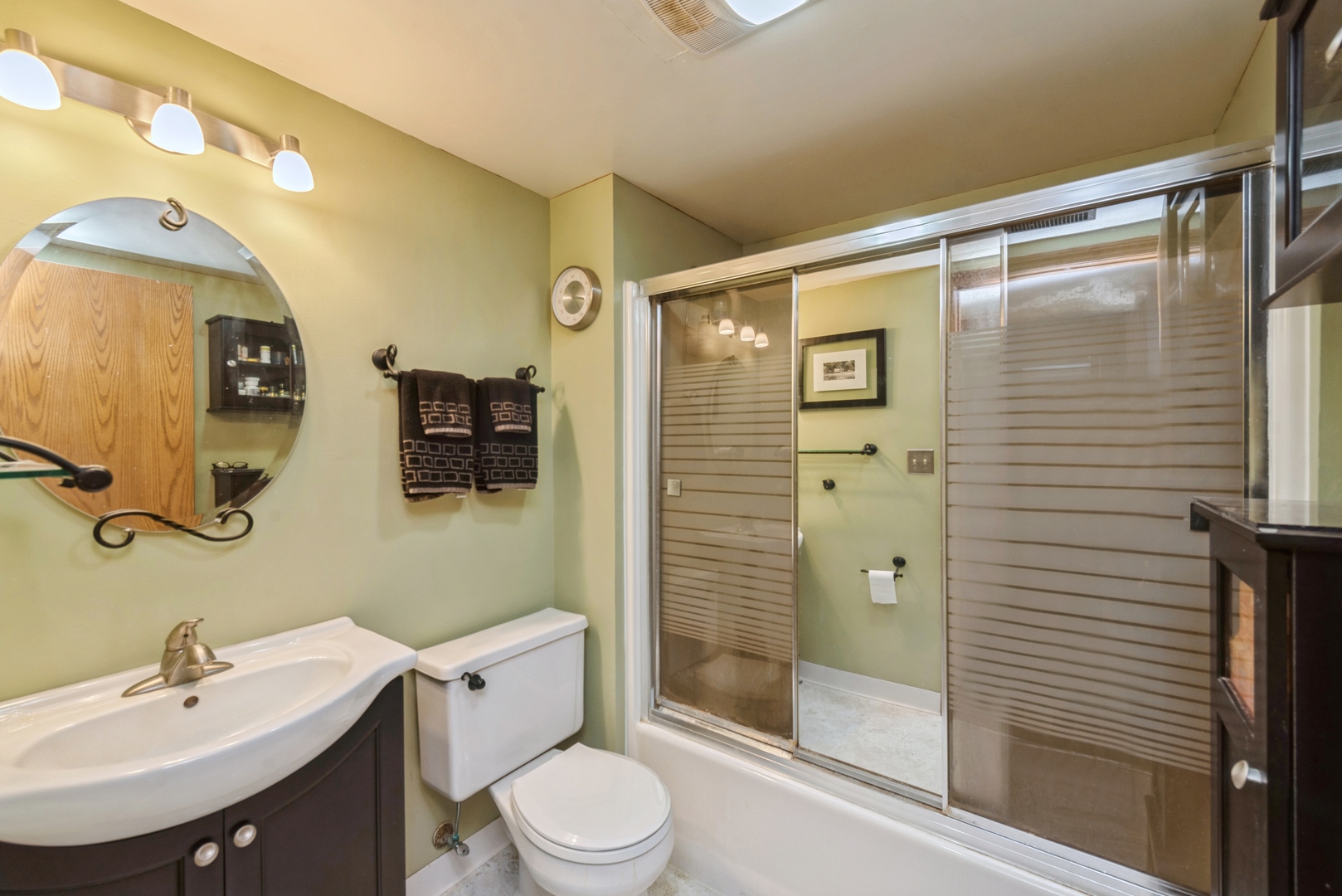 2507 Crystal Lake Road Cary, IL 60013 - Photo 13 of 18 a bathroom with a sink mirror and shower
