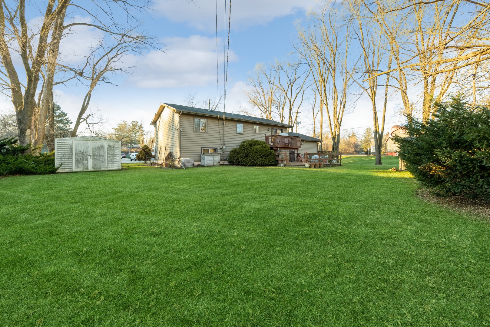 2507 Crystal Lake Road Cary, IL 60013 - Photo 18 of 18 a view of a house with a big yard and large trees