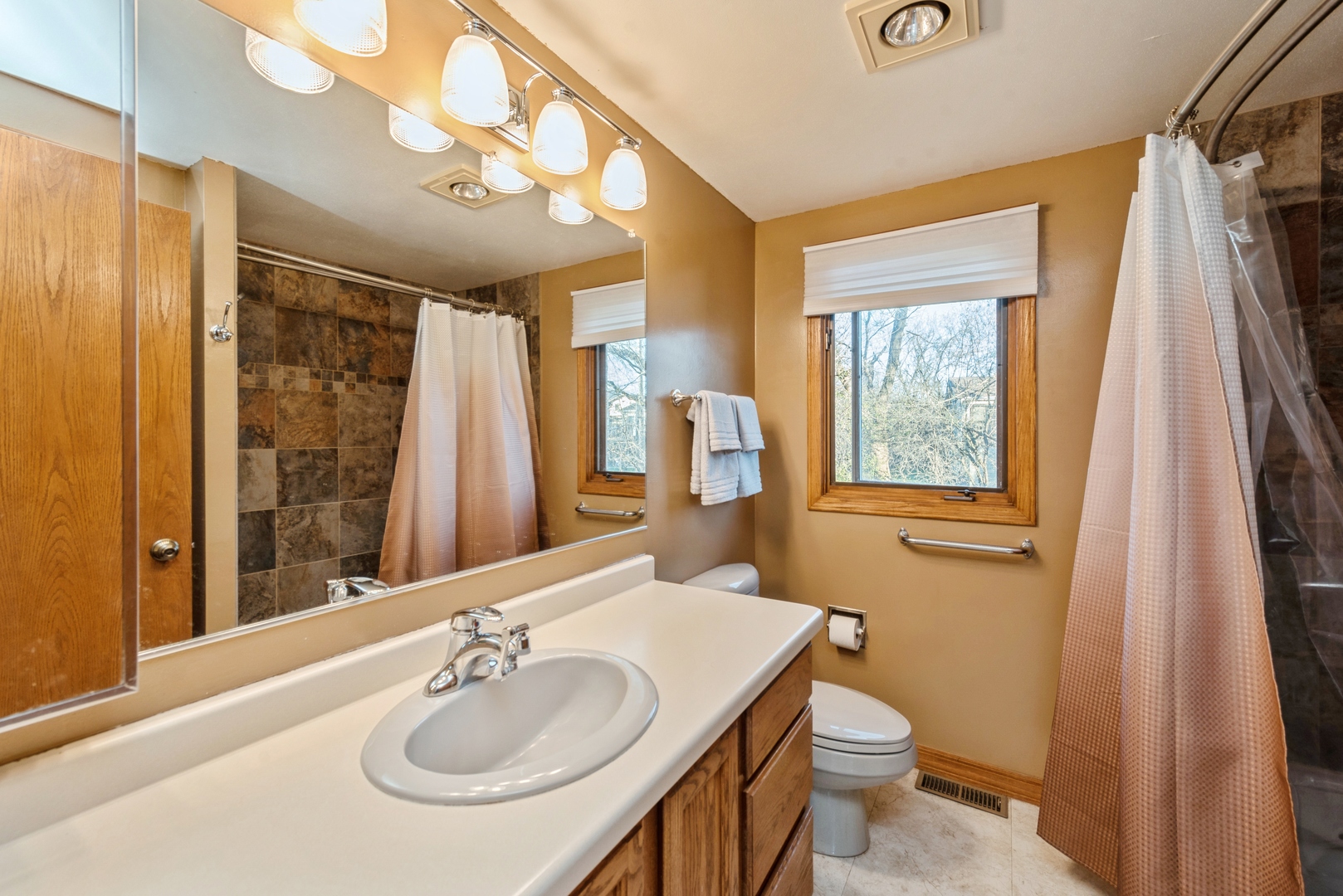 2507 Crystal Lake Road Cary, IL 60013 - Photo 8 of 18 a bathroom with a sink a toilet and shower curtain