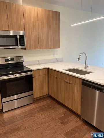 a kitchen with a sink stove and microwave