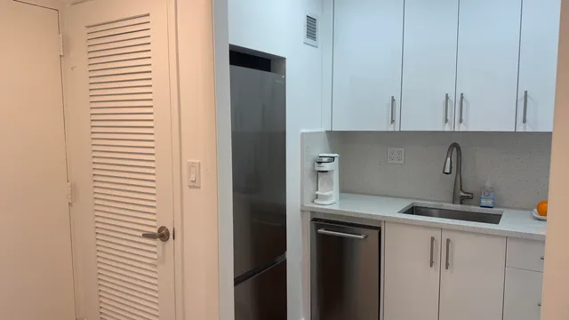 a kitchen with a refrigerator and cabinets