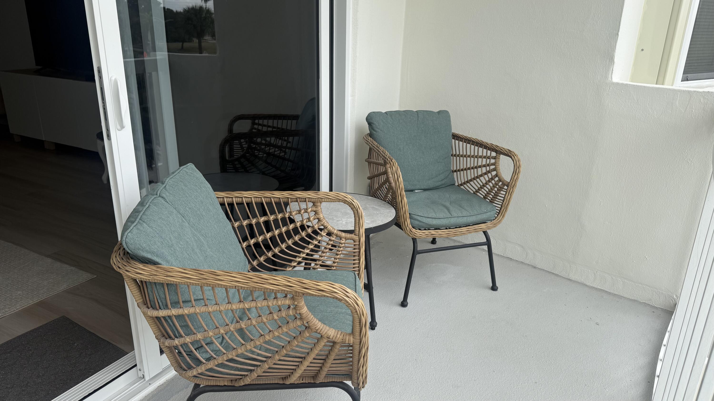 2600 North Flagler Drive, Unit 313 West Palm Beach, FL 33407 - Photo 18 of 19 a chair and a table in a room