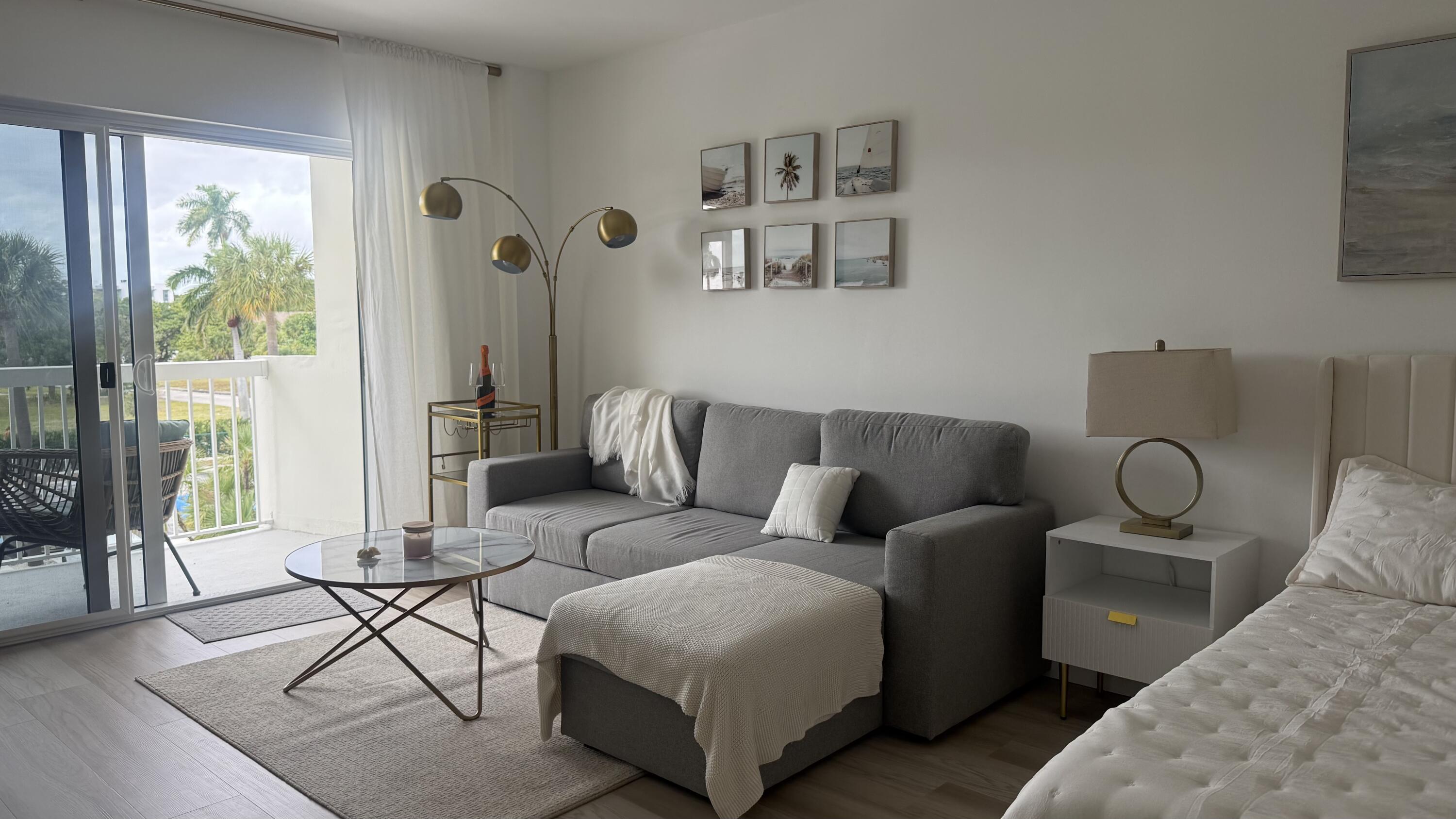 2600 North Flagler Drive, Unit 313 West Palm Beach, FL 33407 - Photo 2 of 19 a living room with furniture and a window