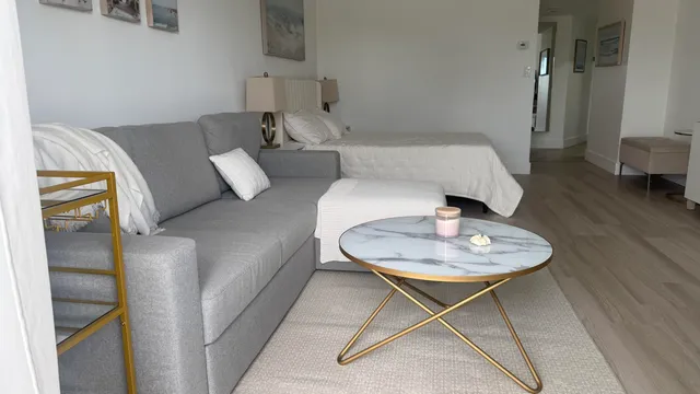 a living room with furniture and a wooden floor