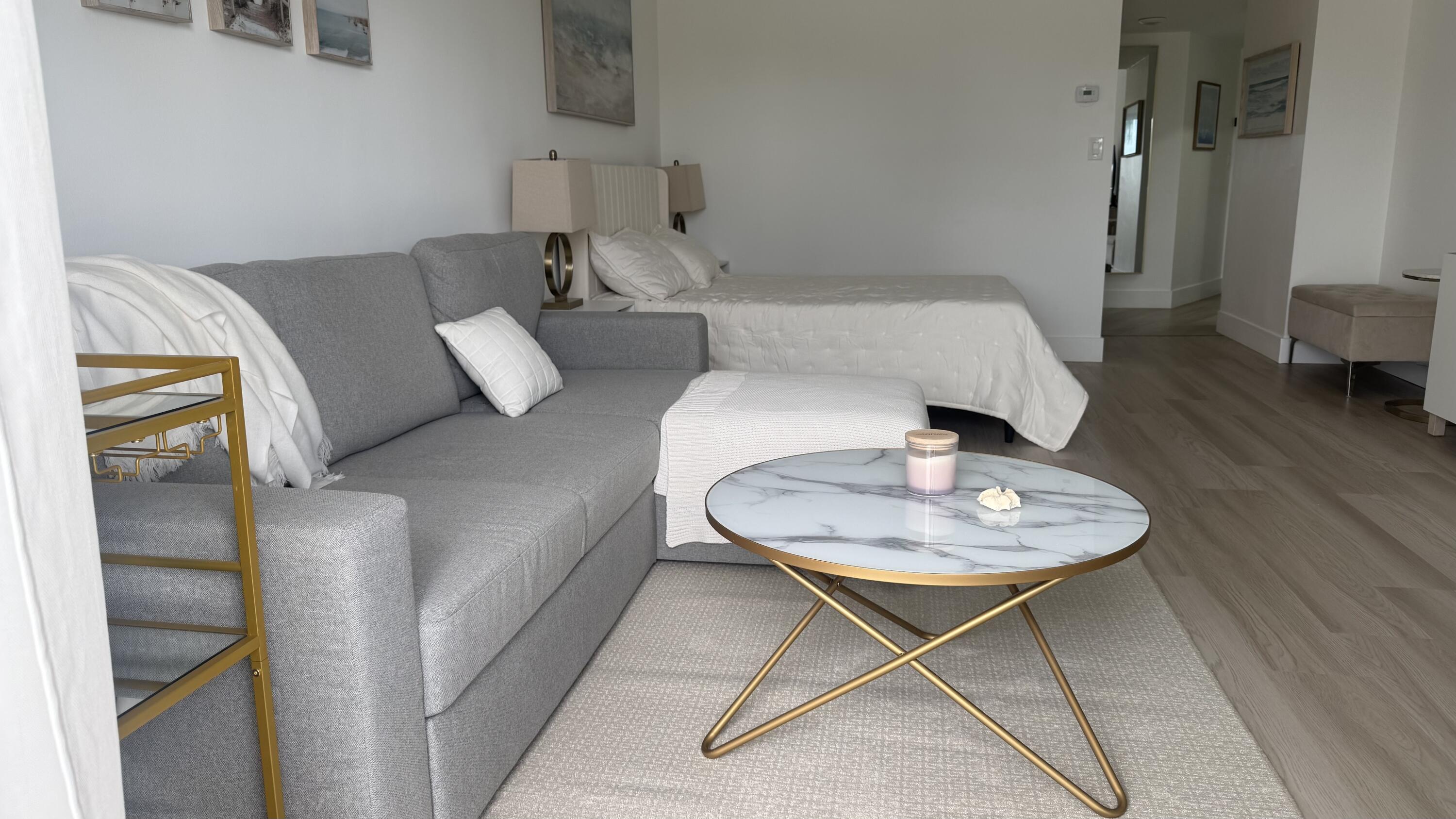 2600 North Flagler Drive, Unit 313 West Palm Beach, FL 33407 - Photo 4 of 19 a living room with furniture and a wooden floor