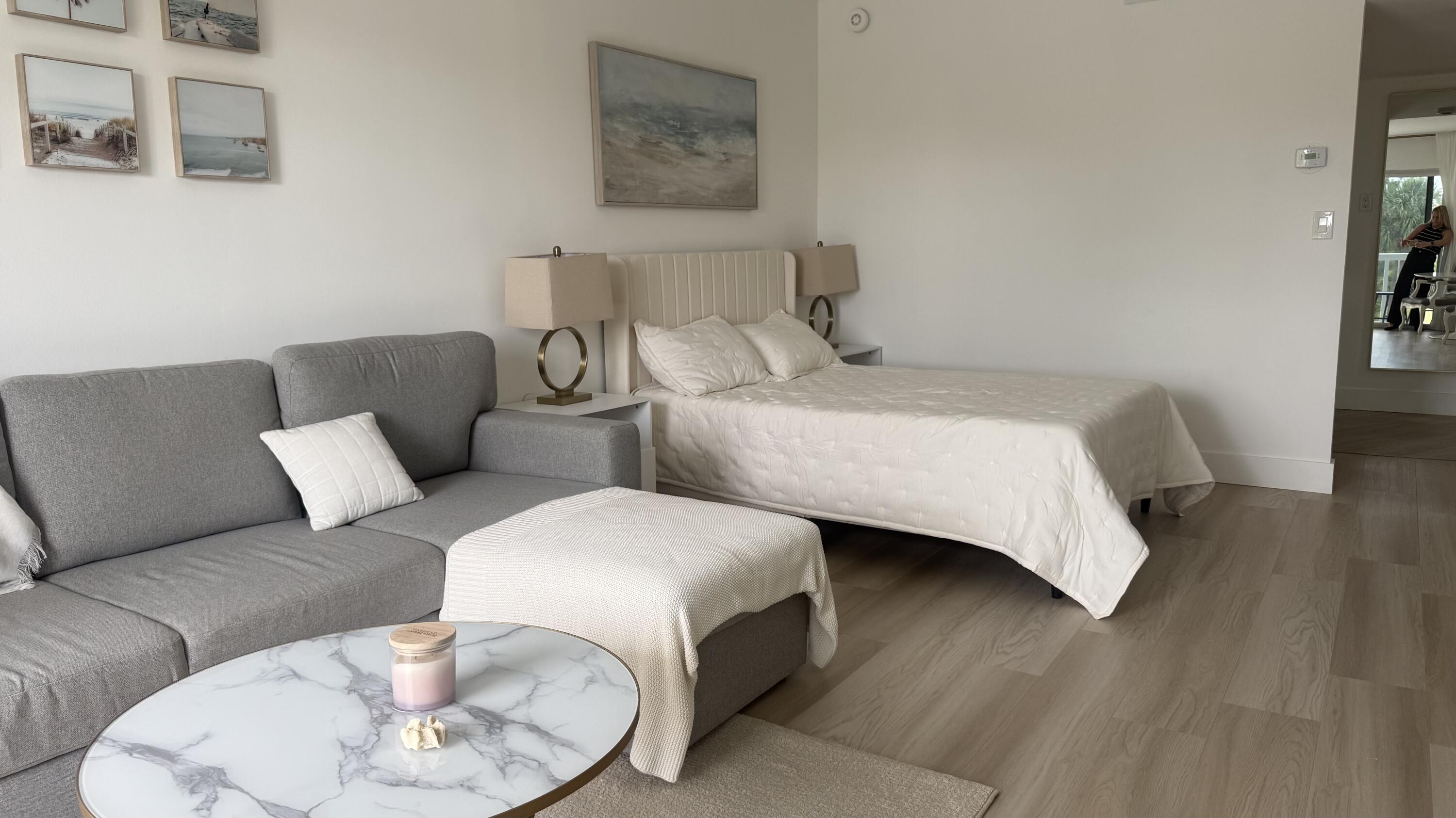 2600 North Flagler Drive, Unit 313 West Palm Beach, FL 33407 - Photo 6 of 19 a bedroom with two beds and a wooden floor