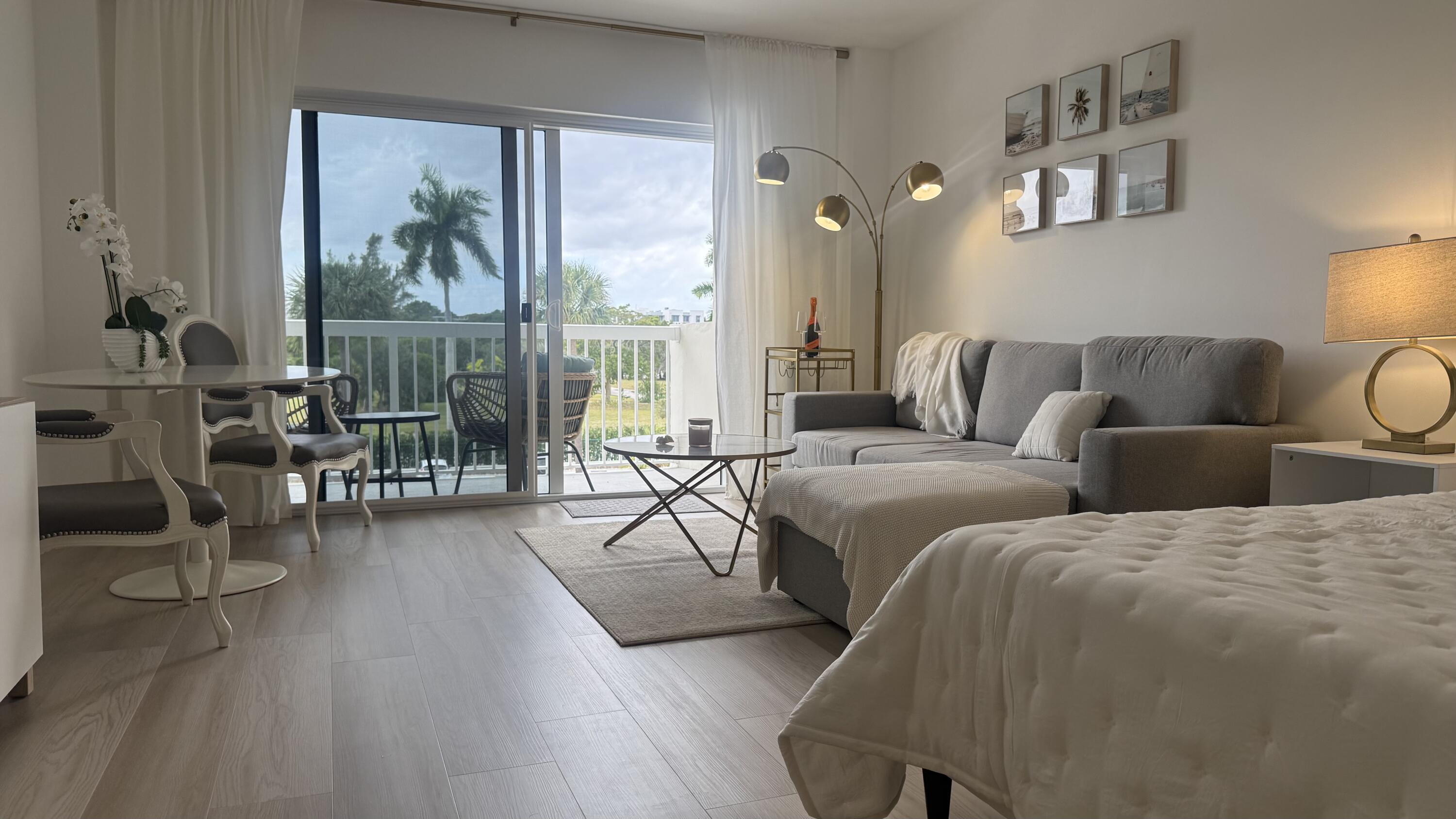 2600 North Flagler Drive, Unit 313 West Palm Beach, FL 33407 - Photo 9 of 19 a living room with furniture and a large window