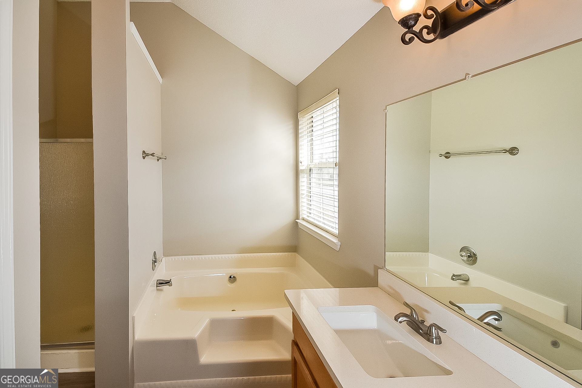 200 Teak Lane Fairburn, GA 30213 - Photo 12 of 17 a bathroom with a tub sink a mirror and a shower