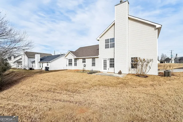 a big house with a yard and pathway