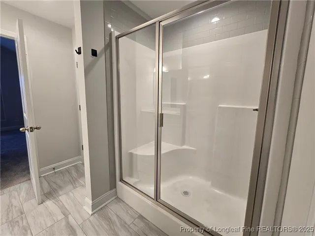 a bathroom with a glass shower door