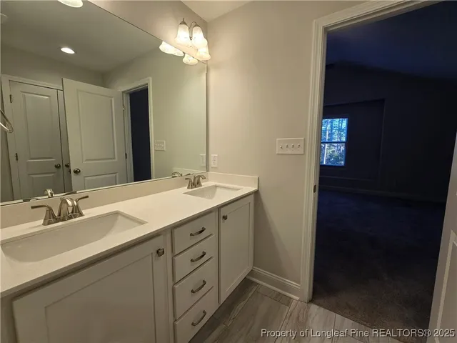 a bathroom with a double vanity sink and a mirror