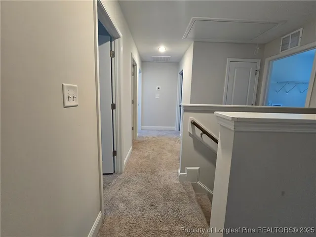 a view of a hallway to rooms