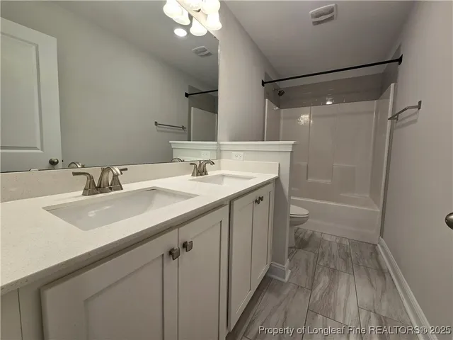a bathroom with a sink a mirror a vanity and shower