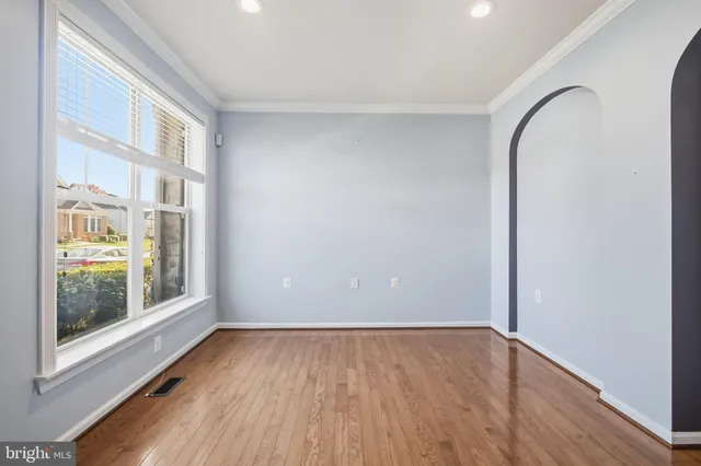 a view of a room with wooden floor and windows