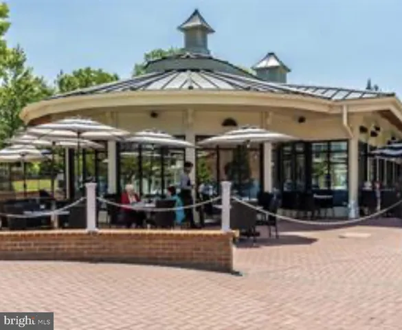 a view of a chairs and a table in the patio and a fountain