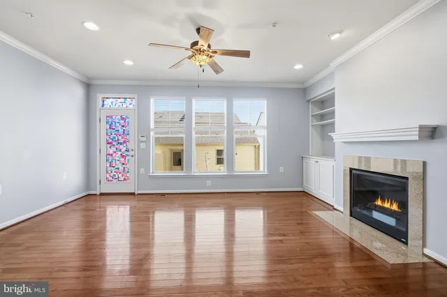 a view of an empty room with exposed radiator and fireplace
