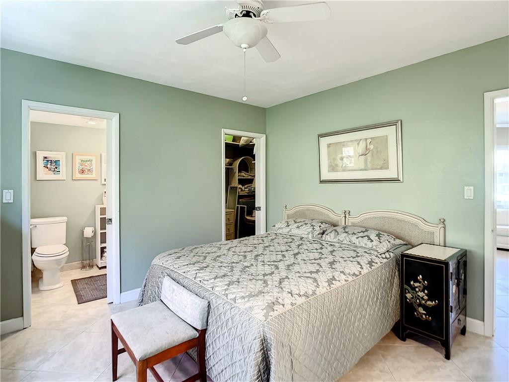 3208 Colony Club Road, Unit 2 Pompano Beach, FL 33062 - Photo 12 of 26 a bedroom with a bed and a table in it