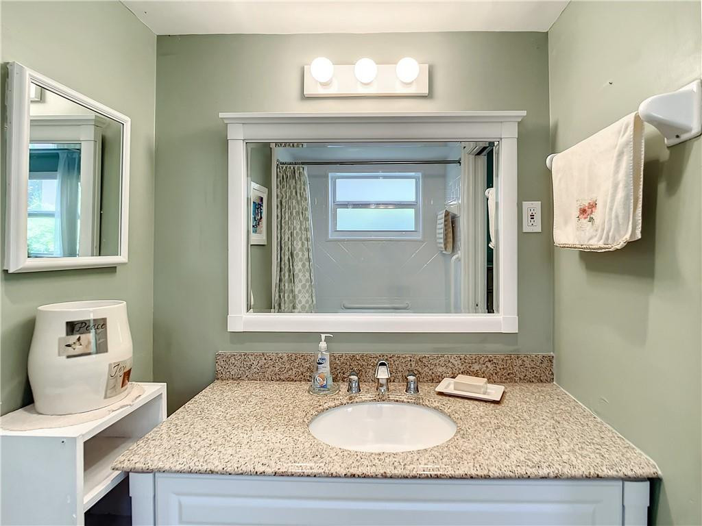 3208 Colony Club Road, Unit 2 Pompano Beach, FL 33062 - Photo 14 of 26 a bathroom with a granite countertop sink and a mirror