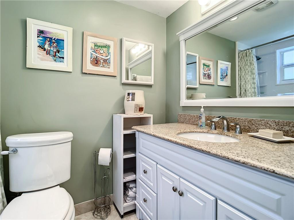 3208 Colony Club Road, Unit 2 Pompano Beach, FL 33062 - Photo 15 of 26 a bathroom with a granite countertop toilet sink and mirror