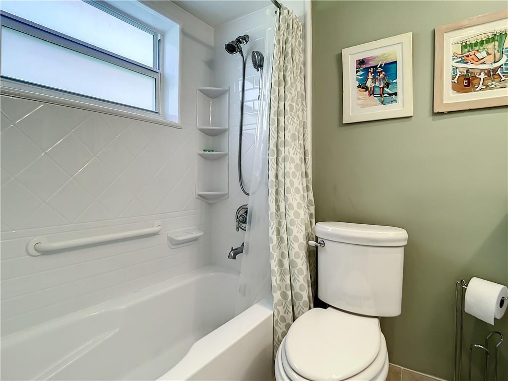 3208 Colony Club Road, Unit 2 Pompano Beach, FL 33062 - Photo 16 of 26 a white toilet sitting next to a bath tub and a shower