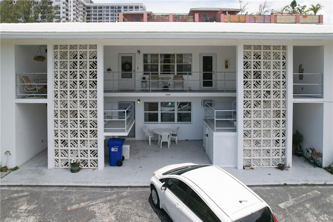 3208 Colony Club Road, Unit 2 Pompano Beach, FL 33062 - Photo 19 of 26 a front view of a building with glass windows